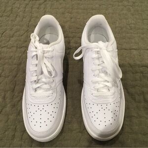 Nike women’s Court Vision low, all white sneakers.
